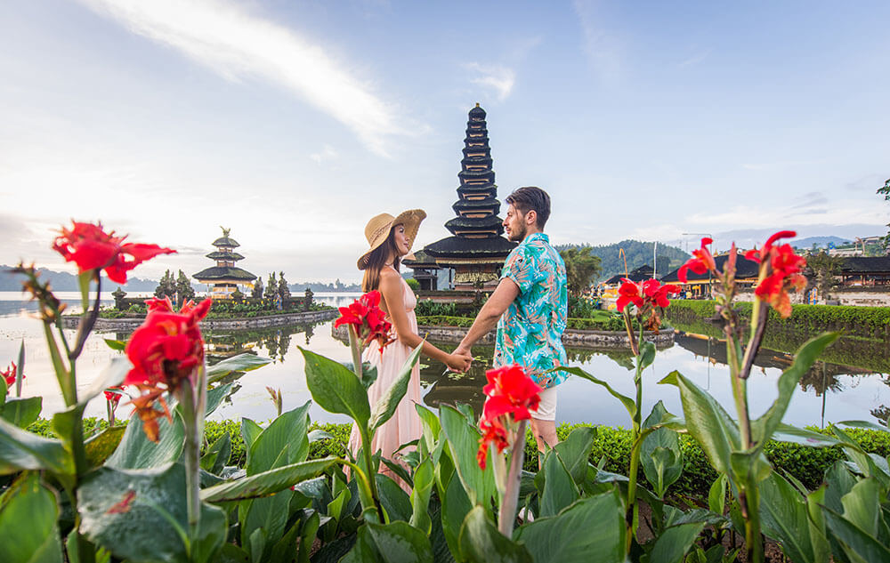 young couple at the pura ulun danu bratan bali 2023 11 27 04 55 45 utc