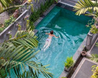 young-woman-swimming-in-the-pool-in-ubud-bali-vi-2022-07-11-03-48-14-utc-1.jpg